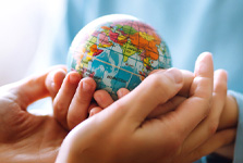 image of hands holding an earth sculpture